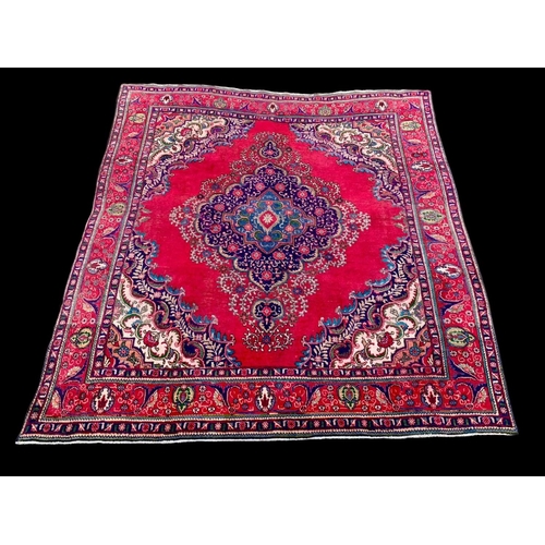 913 - A large vintage Middle Eastern hand knotted rug. 291 x 309cm