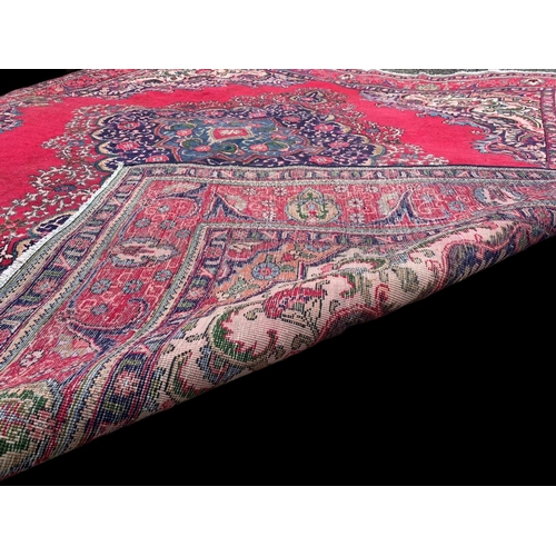 913 - A large vintage Middle Eastern hand knotted rug. 291 x 309cm