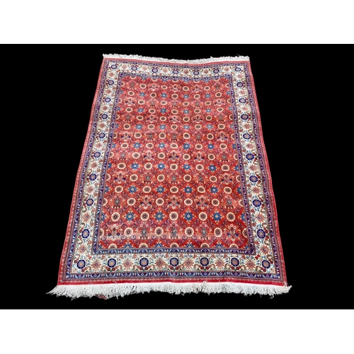 914 - A large Middle Eastern style hand knotted rug. 206 x 304cm.