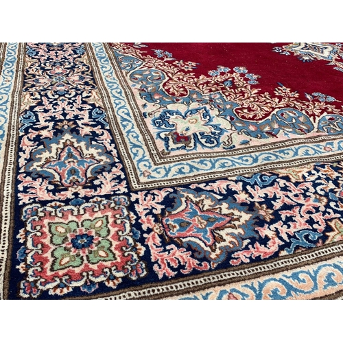 918 - A large vintage Middle Eastern hand knotted rug. 311.5 x 405cm.