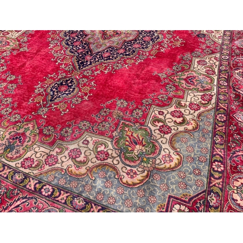 919 - A large vintage Middle Eastern hand knotted rug. 304 x 394cm.