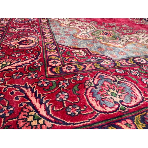 919 - A large vintage Middle Eastern hand knotted rug. 304 x 394cm.