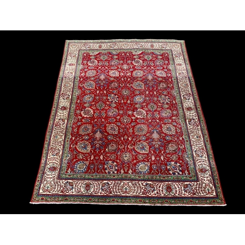 920 - A large vintage Middle Eastern hand knotted rug. 253 x 325cm.