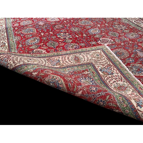 920 - A large vintage Middle Eastern hand knotted rug. 253 x 325cm.