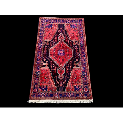 921 - A large vintage Middle Eastern hand knotted rug 141 x 247cm.