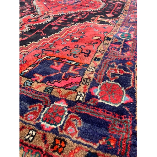 921 - A large vintage Middle Eastern hand knotted rug 141 x 247cm.