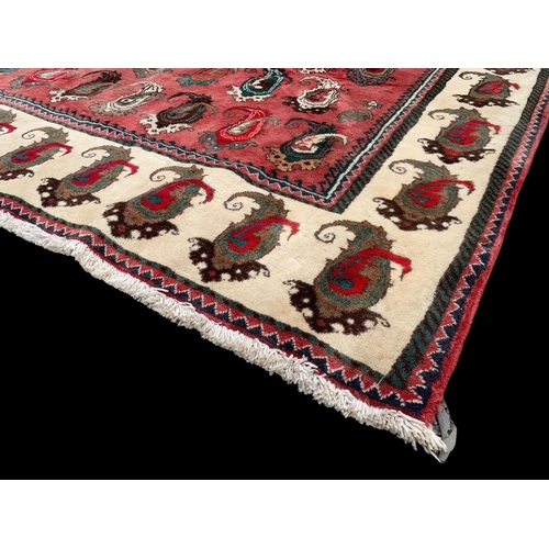 924 - A large vintage Middle Eastern hand knotted rug. 104 x 217cm