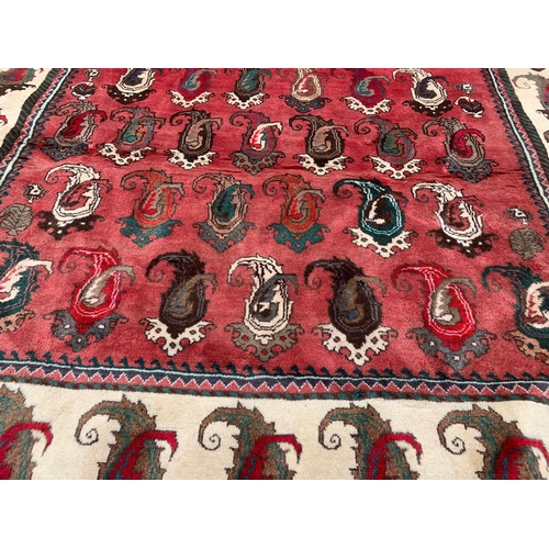 924 - A large vintage Middle Eastern hand knotted rug. 104 x 217cm