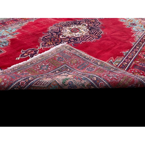 925 - A large vintage Middle Eastern hand knotted rug. 300 x 379.5cm.