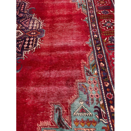 925 - A large vintage Middle Eastern hand knotted rug. 300 x 379.5cm.