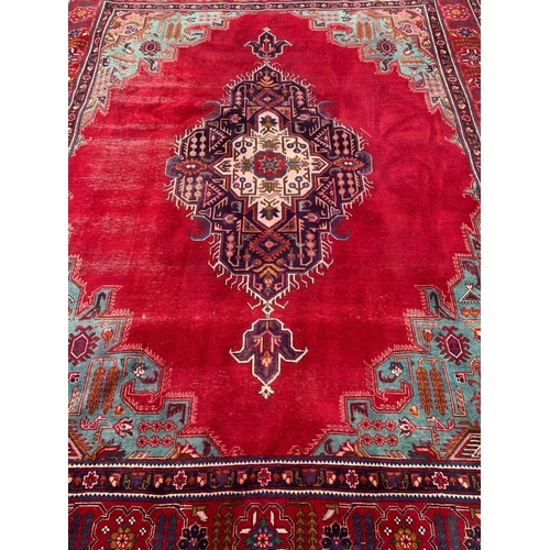 925 - A large vintage Middle Eastern hand knotted rug. 300 x 379.5cm.