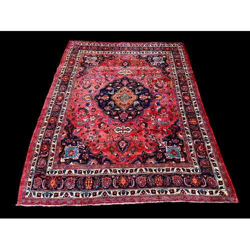 927 - A large vintage Middle Eastern hand knotted rug. 293 x 383cm.