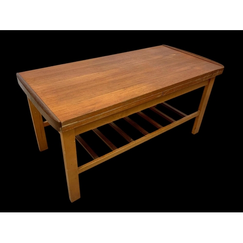 932 - A teak and beech extending coffee table with under storage. 95.5 x 45.5 x 45cm.