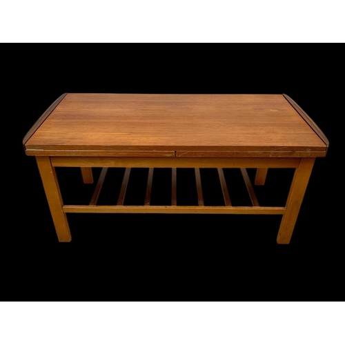 932 - A teak and beech extending coffee table with under storage. 95.5 x 45.5 x 45cm.