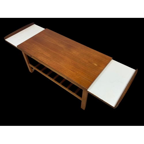 932 - A teak and beech extending coffee table with under storage. 95.5 x 45.5 x 45cm.