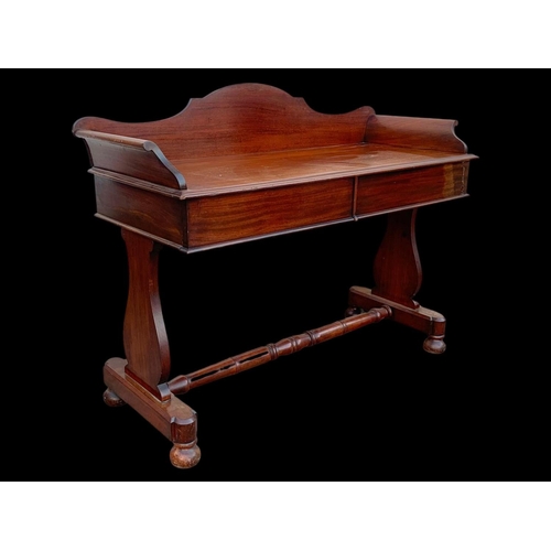 940 - A Victorian mahogany 2 drawer washstand/ gallery back side table. 122 x 51 x 99.5cm.