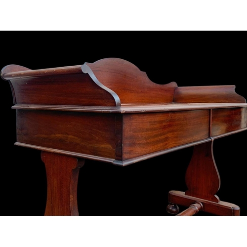 940 - A Victorian mahogany 2 drawer washstand/ gallery back side table. 122 x 51 x 99.5cm.