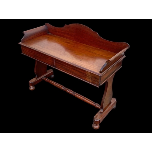 940 - A Victorian mahogany 2 drawer washstand/ gallery back side table. 122 x 51 x 99.5cm.