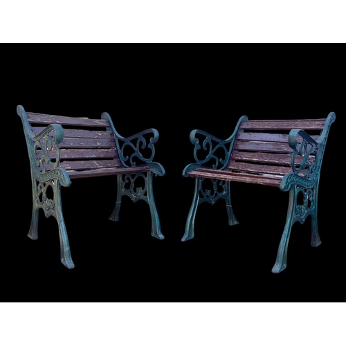 974 - A pair of cast iron garden armchairs.