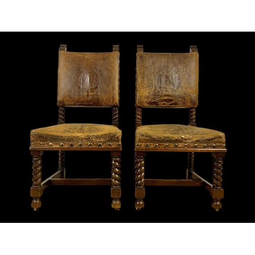 977 - A pair of late 19th century oak rectory chairs in the Jacobean style with original leather and eccle... 