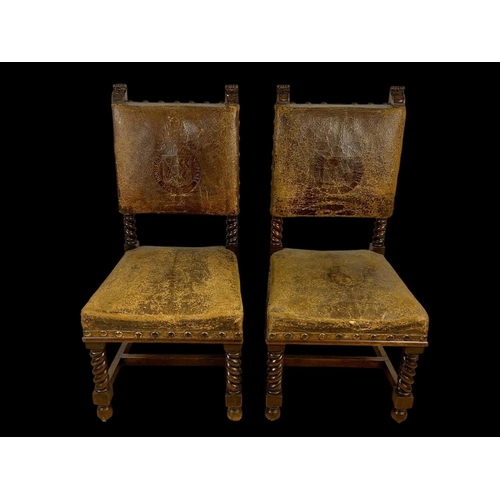 977 - A pair of late 19th century oak rectory chairs in the Jacobean style with original leather and eccle... 