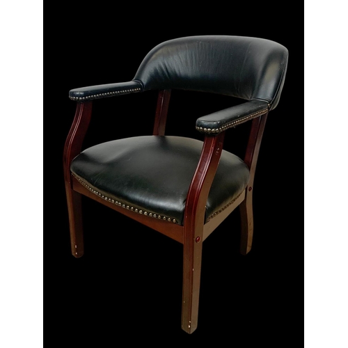 978 - A black faux leather armchair.