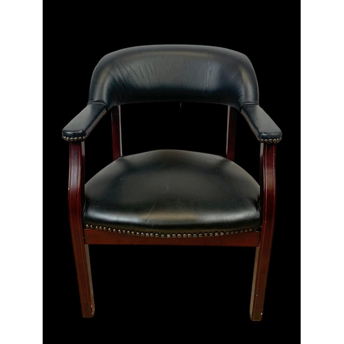 978 - A black faux leather armchair.