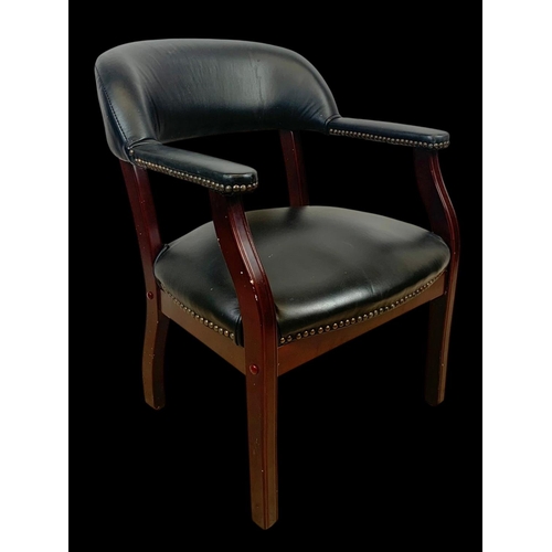 978 - A black faux leather armchair.