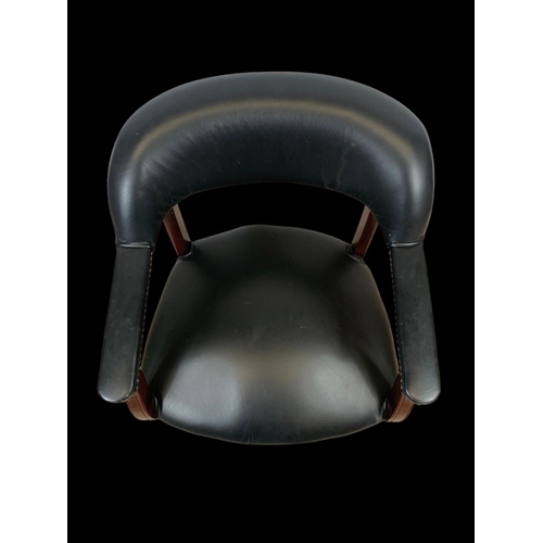 978 - A black faux leather armchair.