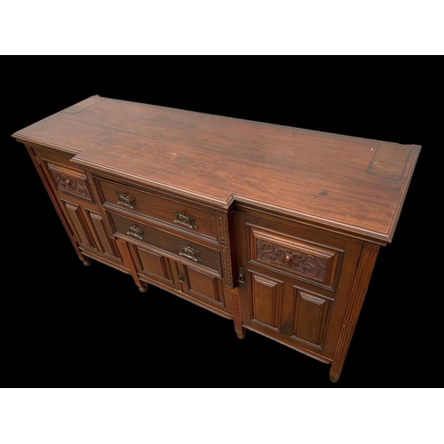 987 - A large Edwardian walnut sideboard with Art Nouveau drop handles. 183 x 62 x 102cm. Including a larg... 