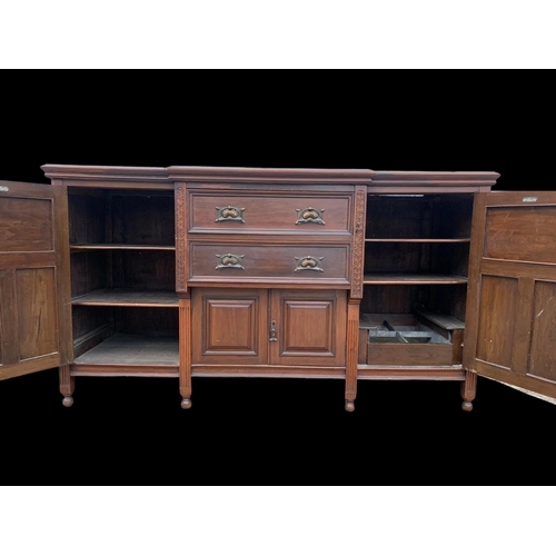 987 - A large Edwardian walnut sideboard with Art Nouveau drop handles. 183 x 62 x 102cm. Including a larg... 