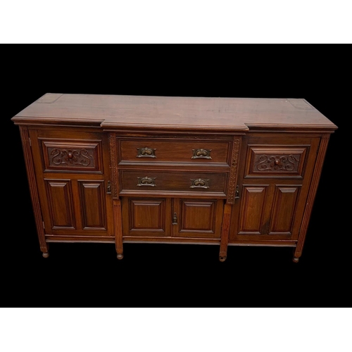 987 - A large Edwardian walnut sideboard with Art Nouveau drop handles. 183 x 62 x 102cm. Including a larg... 