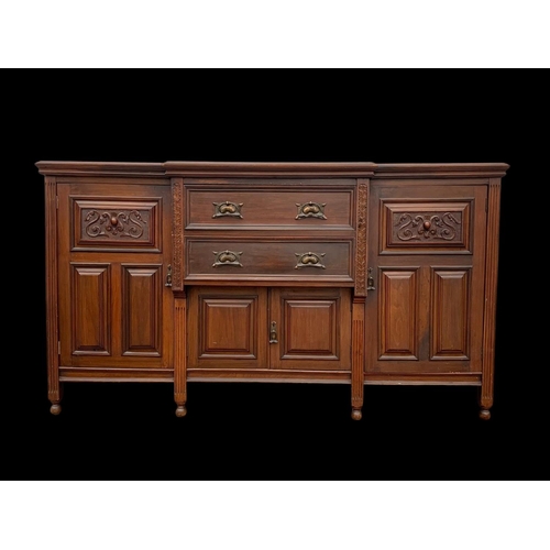 987 - A large Edwardian walnut sideboard with Art Nouveau drop handles. 183 x 62 x 102cm. Including a larg... 