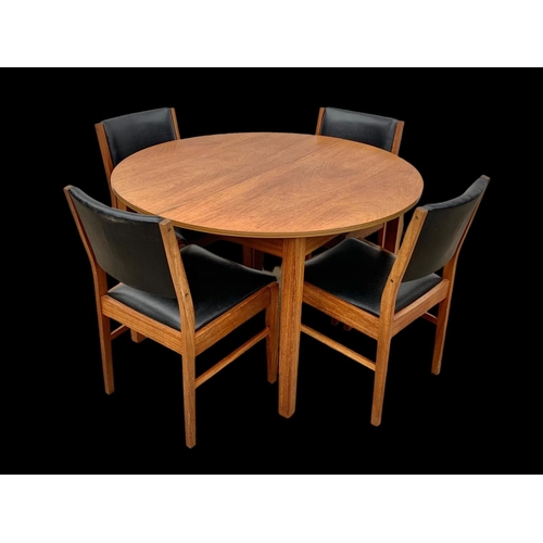 1015 - A teak extending dining table and 4 chairs with black vinyl seats. Mid century. Circa 1960’s. Table ... 