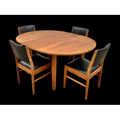 1015 - A teak extending dining table and 4 chairs with black vinyl seats. Mid century. Circa 1960’s. Table ... 