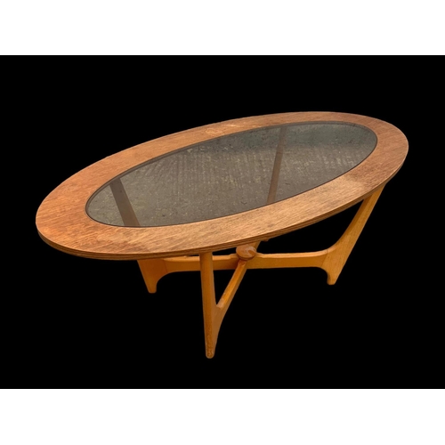 1025 - A teak and bench Astro coffee table with smoked glass top. Mid century. Circa 1960-1970. 107 x 53.5 ... 