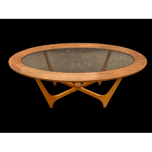 1025 - A teak and bench Astro coffee table with smoked glass top. Mid century. Circa 1960-1970. 107 x 53.5 ... 