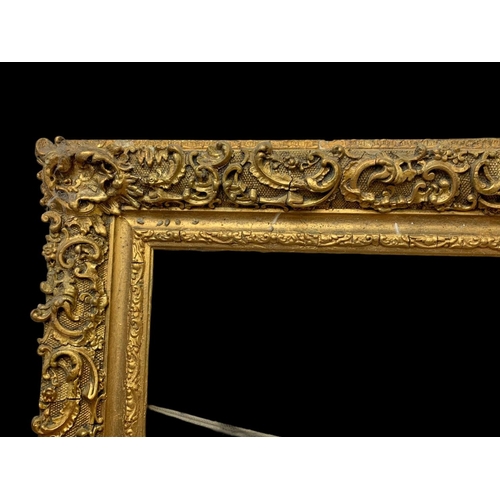 196 - A large Victorian ornate gilt frame with glass. 104 x 8.5 x 79cm