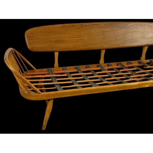 830 - An Ercol Blonde elm model number 355 Studio Daybed Sofa. Mid century. Circa 1960. 209cm.