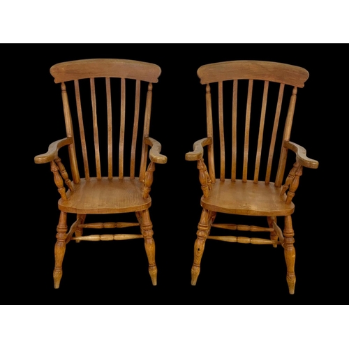 890 - A pair of Victorian style beech farmhouse high back armchairs. 114.5cm ground to back