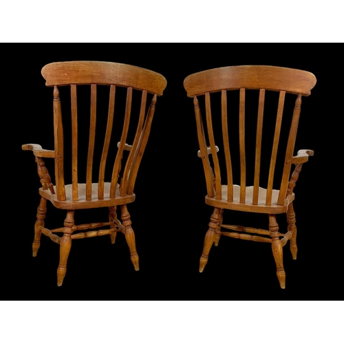 890 - A pair of Victorian style beech farmhouse high back armchairs. 114.5cm ground to back