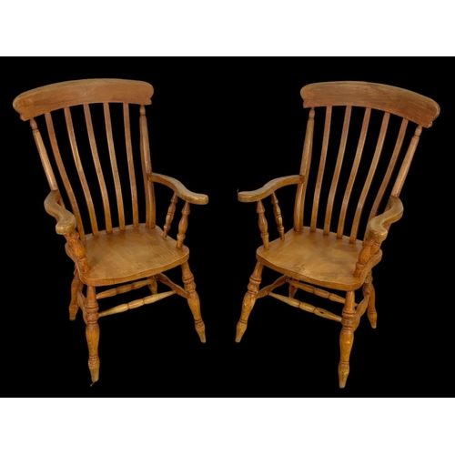 890 - A pair of Victorian style beech farmhouse high back armchairs. 114.5cm ground to back