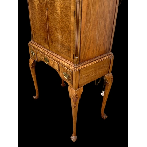 904 - An early Georgian style burr walnut cocktail cabinet, with 3 drawers and glass interior shelves. Cir... 