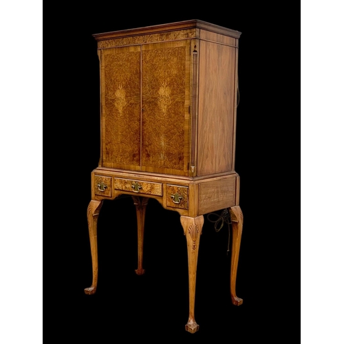 904 - An early Georgian style burr walnut cocktail cabinet, with 3 drawers and glass interior shelves. Cir... 