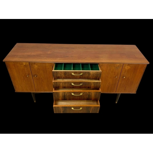 943 - A teak sideboard with 3 drawers and 2 cupboards. Mid century. Circa 1960. 170 x 48.5 x 77.5cm.