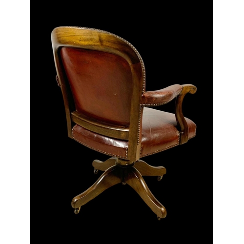 945 - An early 20th century mahogany and leather swivel desk chair. Circa 1920. 65 x 60 x 92cm.