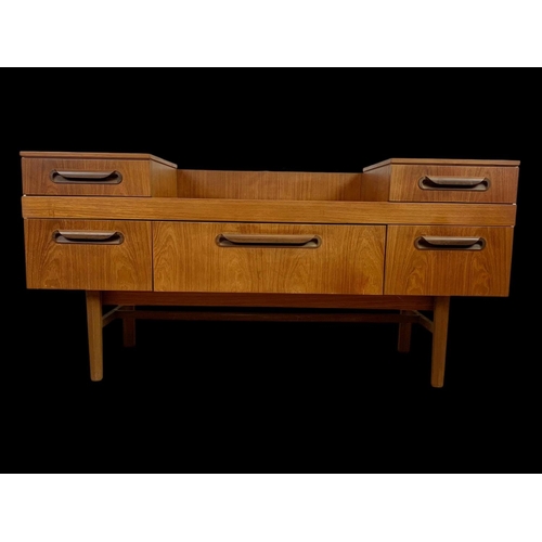 954 - A teak dressing table/sideboard with 5 drawers. Mid century. Circa 1970. 137 x 42 x 66.5cm.