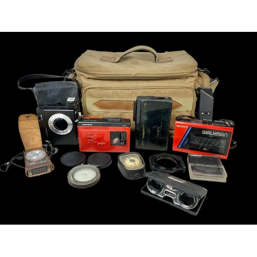 142 - Cassette players and camera equipment. A Sony, Daewoo Yoyo and Stereo cassette players, Pentax and R... 