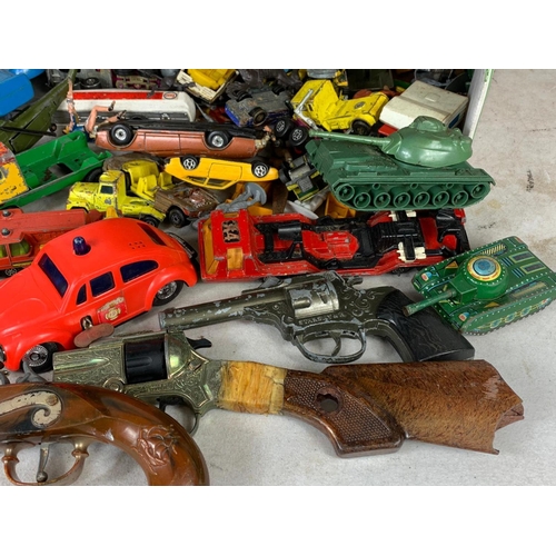 145 - A box of vintage toys/model cars and soldiers. Including tinplate tanks, Dinky, Corgi, Matchbox, pla... 