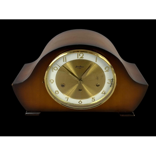 219 - A vintage mantle clock by Bentima. With key. 37 x 23cm.